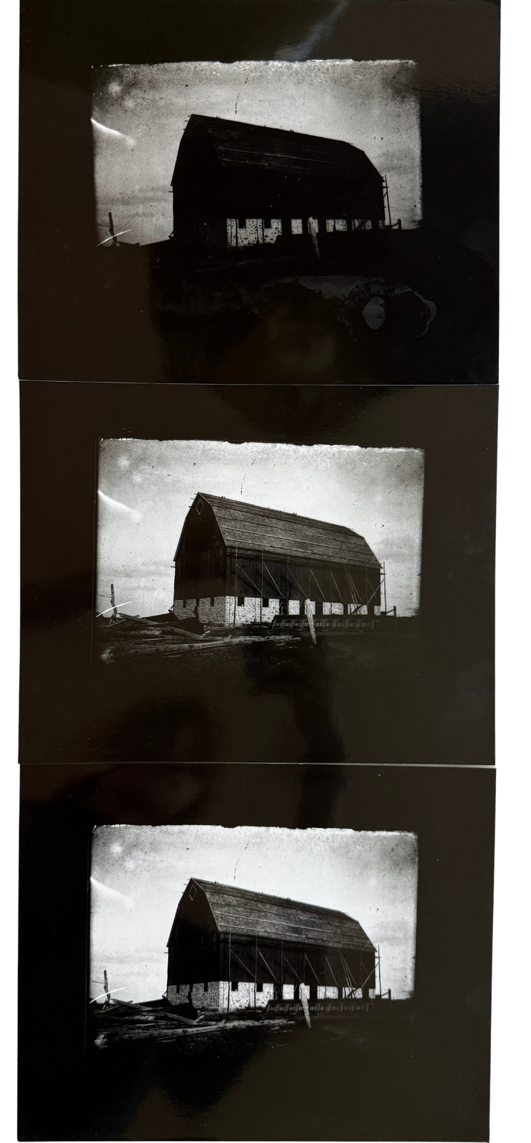 Three black-and-white prints of an old barn